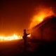 A firefighter battles the Woolsey Fire in Malibu