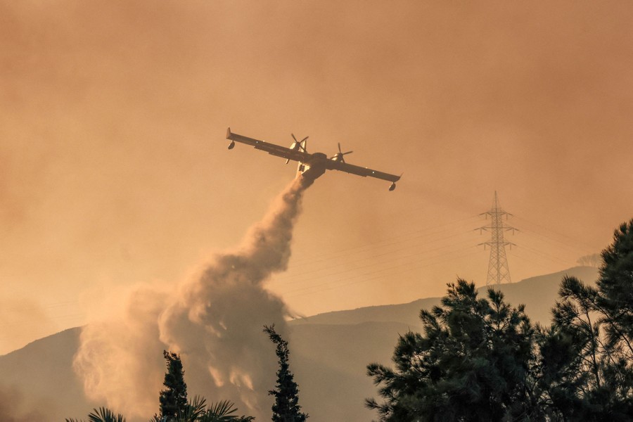 A firefighting plane makes a water drop.