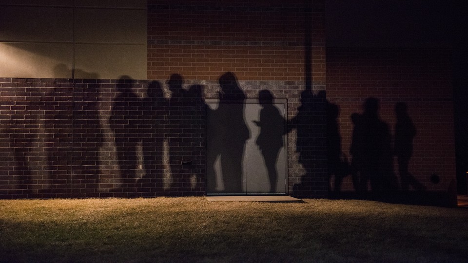 The shadows of voters lined up outside a 2016 caucus location in West Des Moines, Iowa.