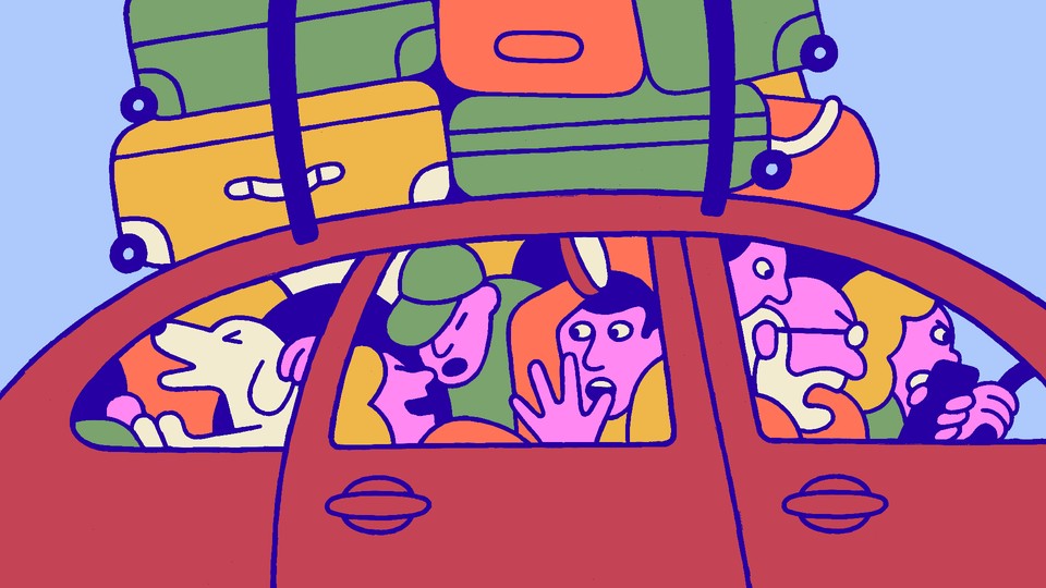 A car piled with luggage and crowded with family