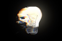 Image of a bright lightbulb smeared into pixelation