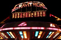 A gravitron ride at a carnival at night