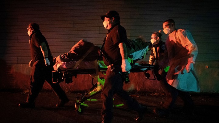 Firefighters and paramedics with Anne Arundel County Fire Department transport a patient on a stretcher in Glen Burnie, Maryland