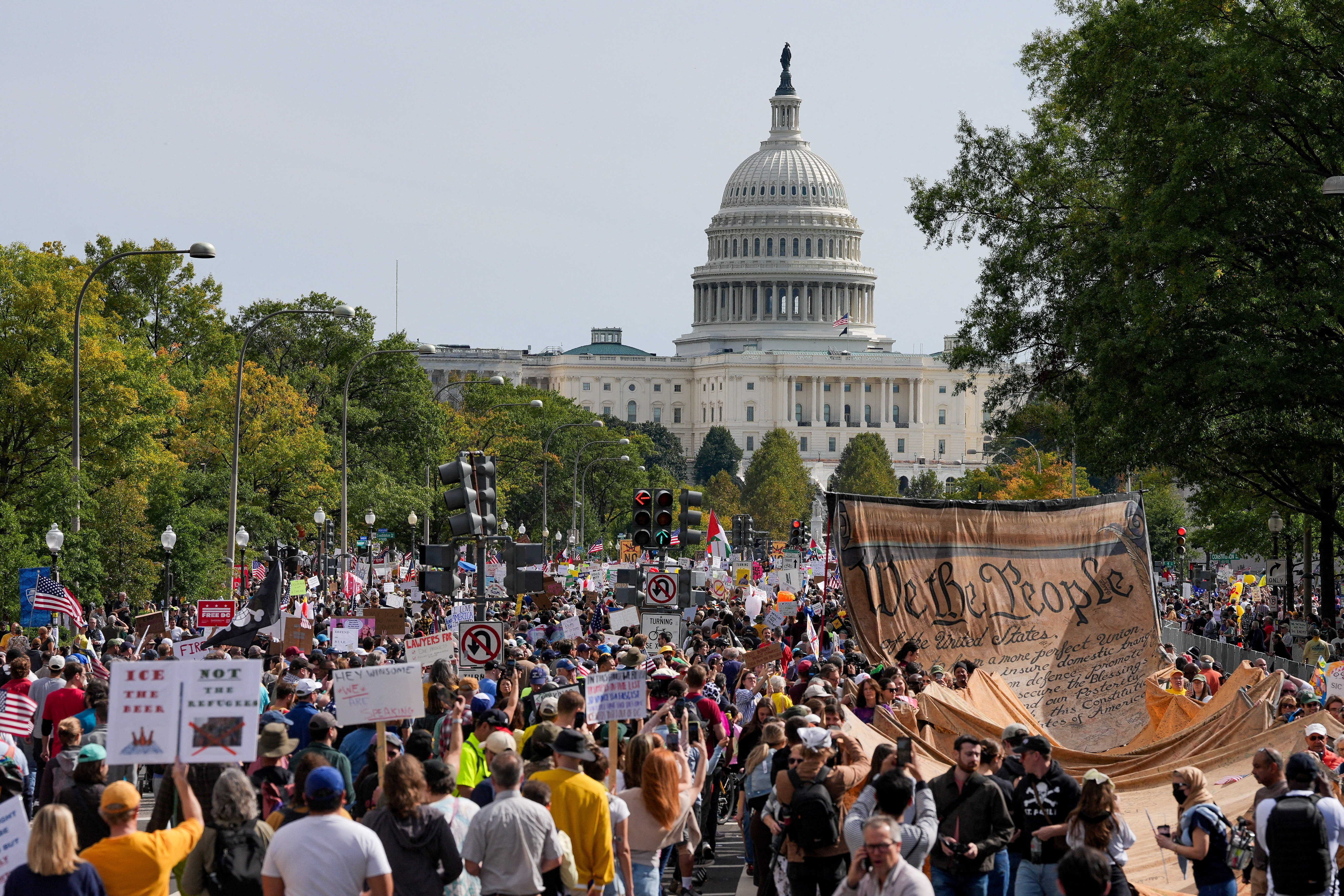 Protesters march toward the U.S. Capitol building. Some carry a large replica of the U.S. Constitution.
