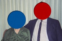 Picture of couple, with blue dot covering woman's face and red dot covering man's