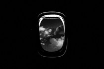 A dark illustration of an airplane window