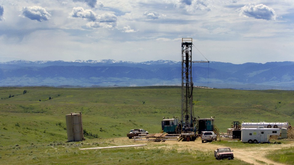 A drilling rig backed by mountains in Wyoming