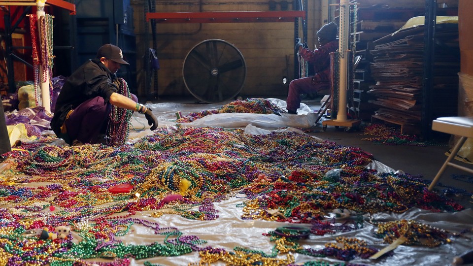 Sorting through Mardi Gras beads to recycle in New Orleans.
