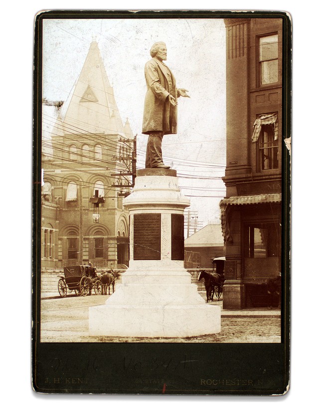 A sepia-toned photograph of a statue of Frederick Douglass