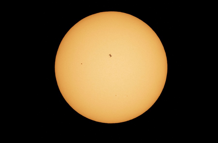 The ISS silhouetted against the face of the sun