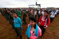 FARC fighters stand in a field