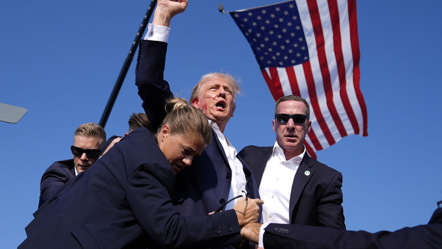 The Republican presidential candidate, former President Donald Trump, is surrounded by U.S. Secret Service agents after an attempted assassination at a campaign rally on July 13, 2024, in Butler, Pennsylvania.