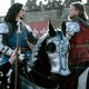 Adam Driver and Matt Damon are seen in armor, on horseback, staring each other down