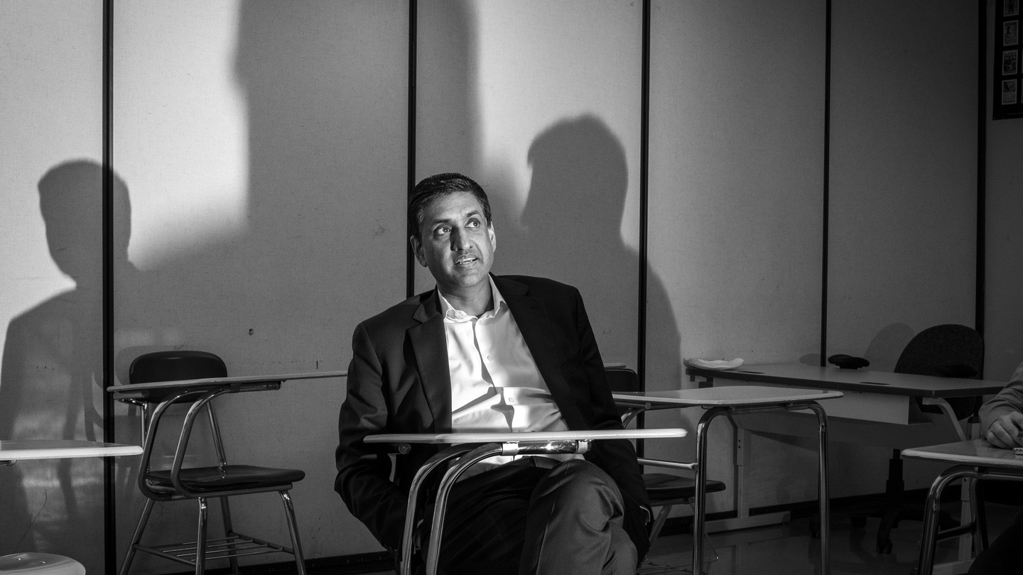 Black-and-white photo of Ro Khanna sitting at a desk in a classroom
