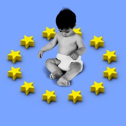 a baby sitting inside a representation of the EU flag as toy star blocks