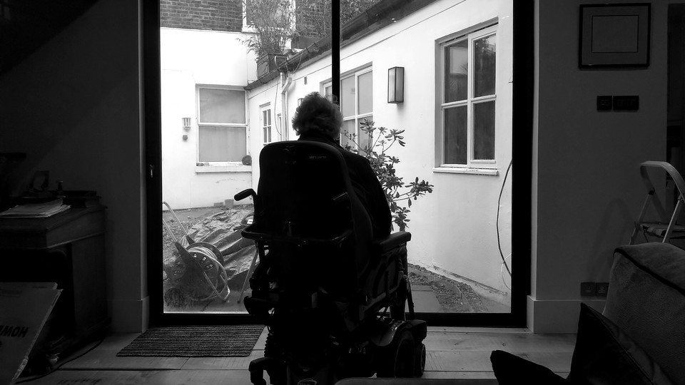 A man sitting by a window.