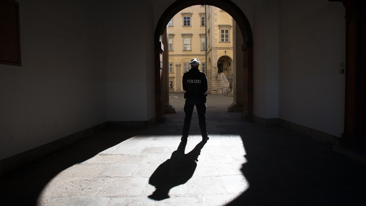 A police officer stands in an archway
