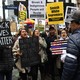 Black Lives Matter activists hold signs reading, "Black lives matter," "smash white supremacy," and "brown and indigenous people will resist."