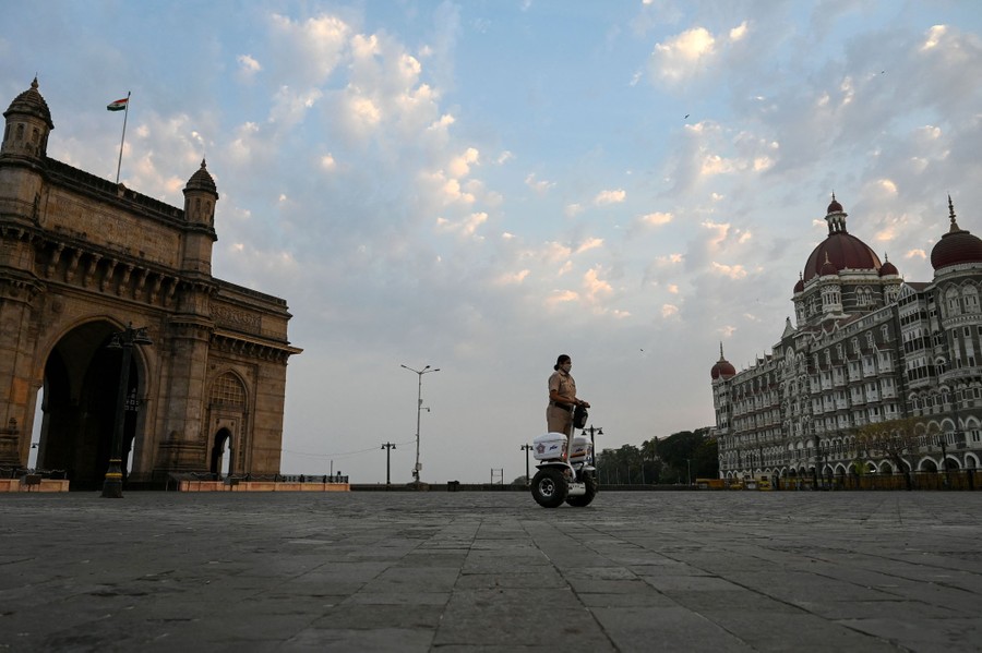 A policewoman rides a Segway in deserted area in Mumbai.