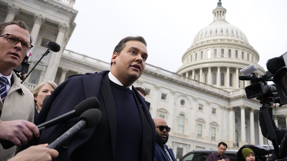 George Santos leaving the U.S. Capitol surrounded by journalists