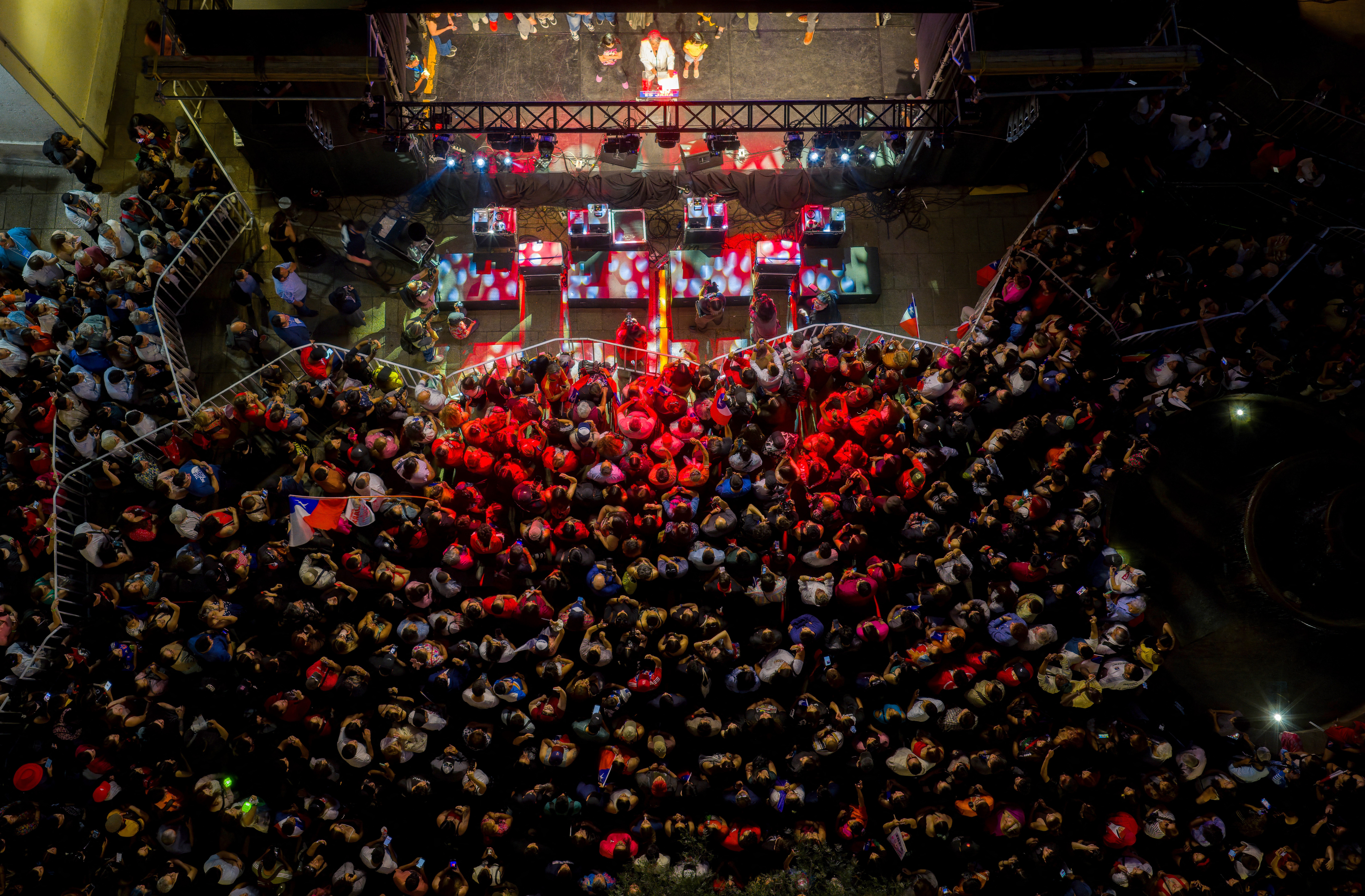 An aerial view of a crowd gathered in front of a stage to see a presidential candidate in Chile.