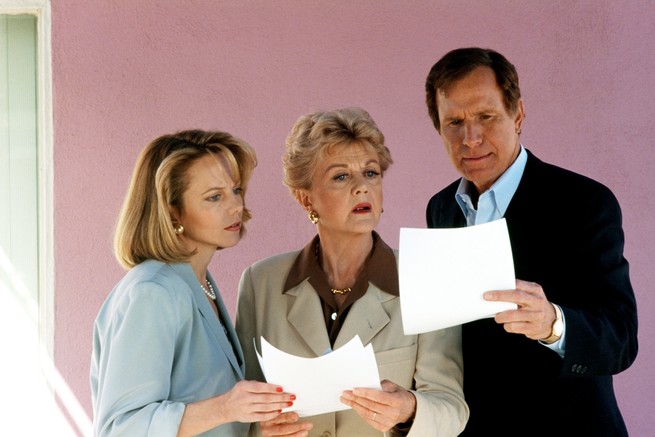 Angela Lansbury and two associates examine papers in "Murder, She Wrote"