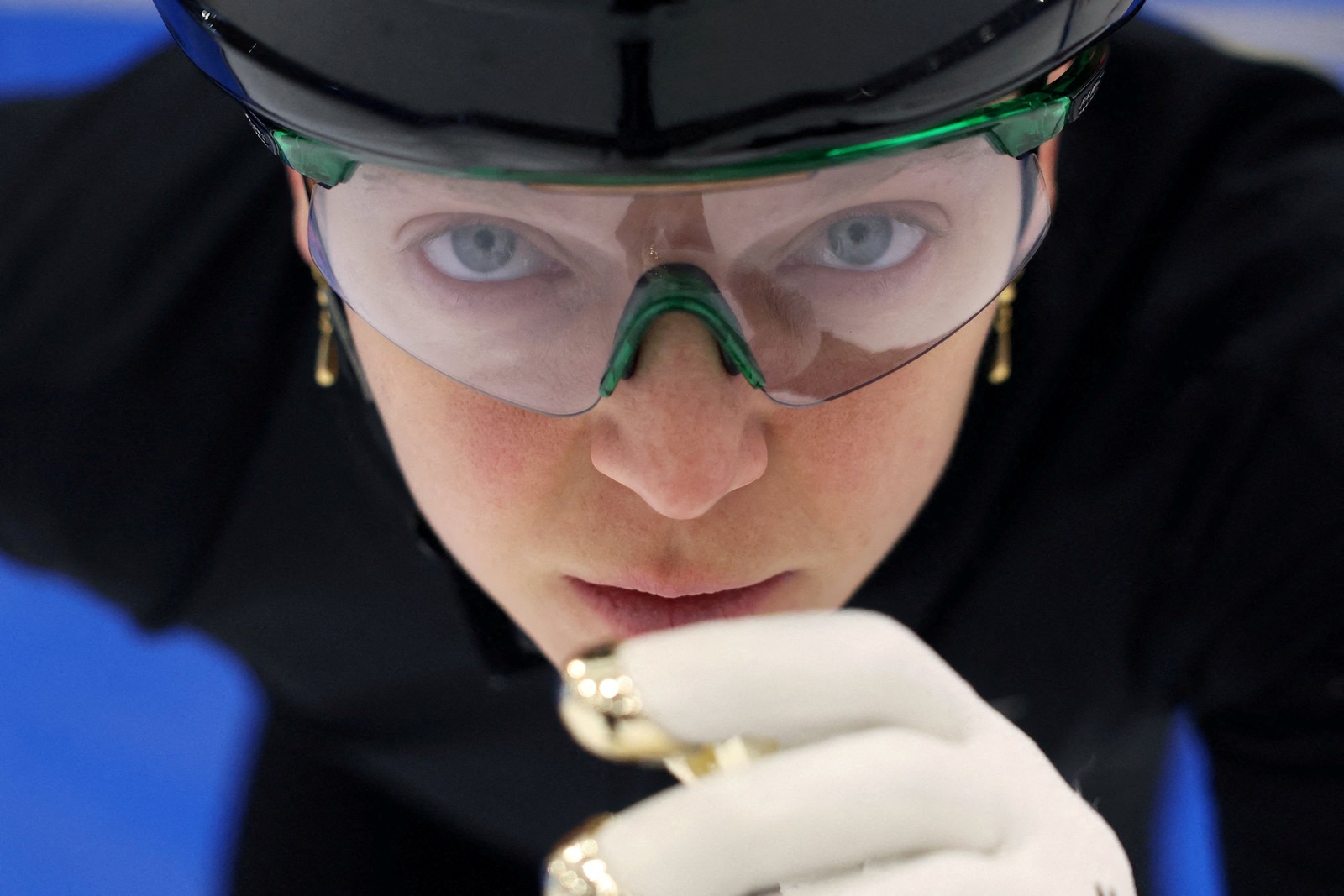 A close view of the face of an ice skating racer, before the start of a race.