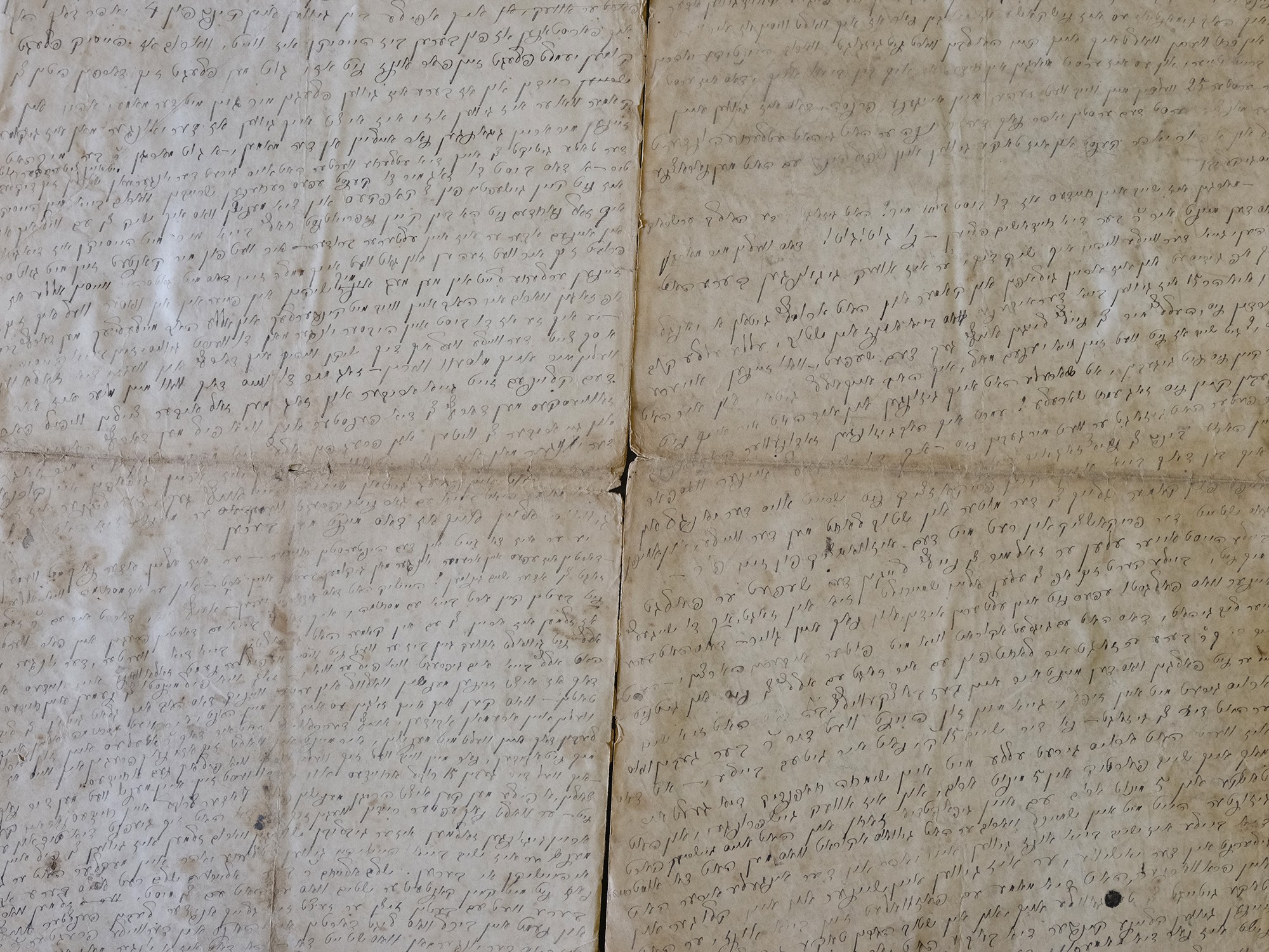 photo of multiple pages of manuscript covered with dense, faded handwriting
