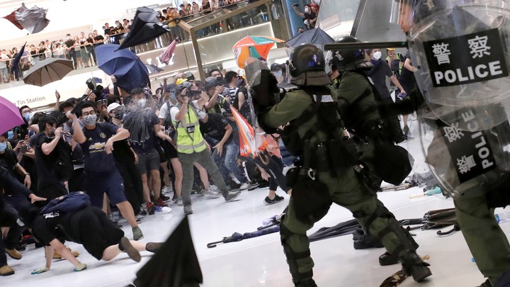 Hong Kong riot police use pepper spray to disperse protesters in a suburban shopping mall.