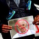 A protester in Dublin holds a picture of Pope Francis during a demonstration against clerical sex abuse.