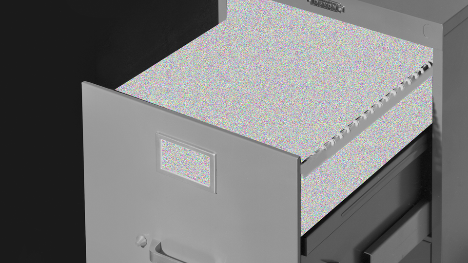 Open filing-cabinet drawer whose contents have been replaced with TV-static screen