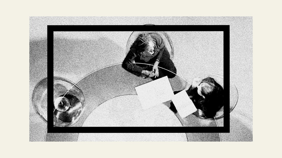 An illustration of two corporate workers sitting at a desk looking at papers