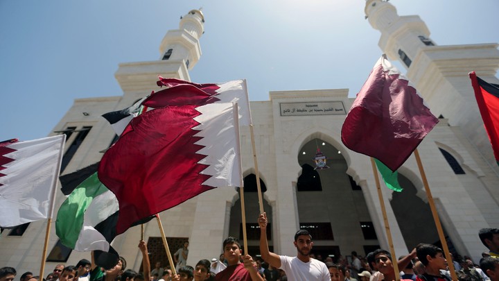 Palestinians take part in a rally in support of Qatar, inside Qatari-funded construction project 'Hamad City', in the southern Gaza Strip onJune 9, 2017.