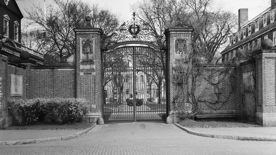 An archival photograph of Harvard University's main gate