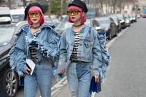 Two women with pink hair dressed in matching denim outfits