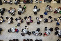 Patrons of a shopping mall sit at tables to eat