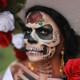 A person wearing elaborate skull makeup