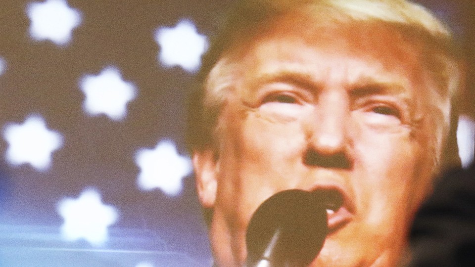 trump speaking into mic