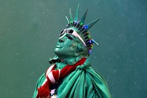 A street performer dressed as the Statue of Liberty stands amongst light snow in Times Square, in New York, in December 2014. 