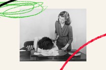 Woman consoling friend with head facing down on desk