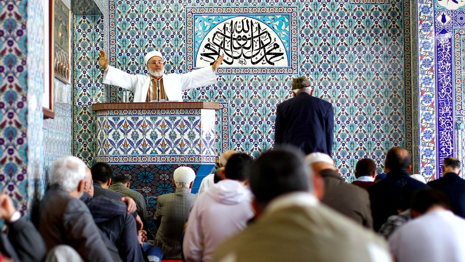 An imam holds Friday prayers at the Central Mosque in the German town of Hamburg