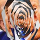 A graphic illustration of an image of Elon Musk getting smaller as it twists against the backdrop of an image of President Donald Trump.