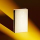 A book stands alone casting a shadow.