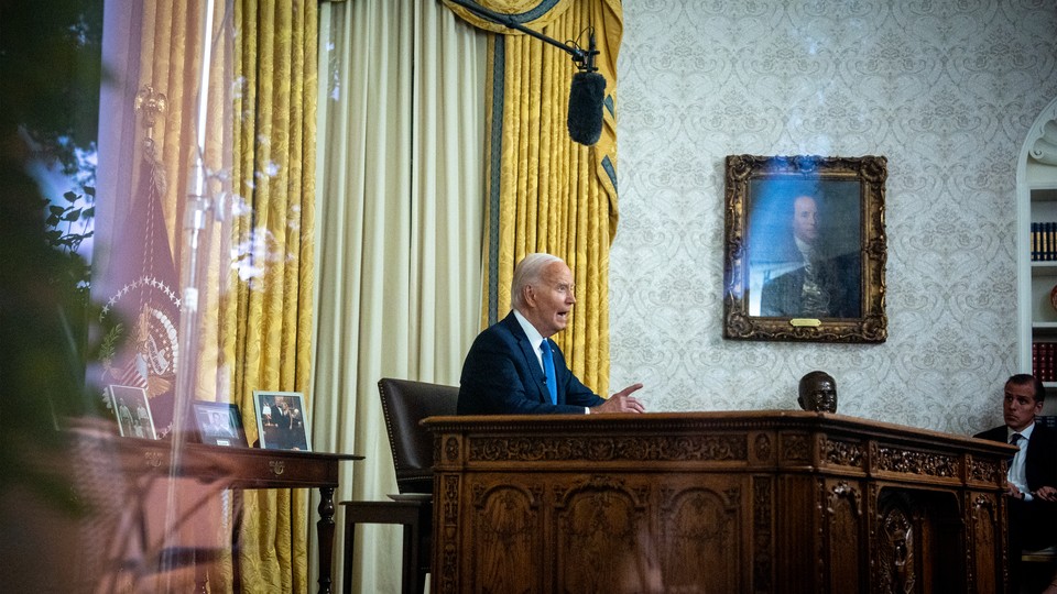 Joe Biden speaking at the Resolute desk in the Oval Office