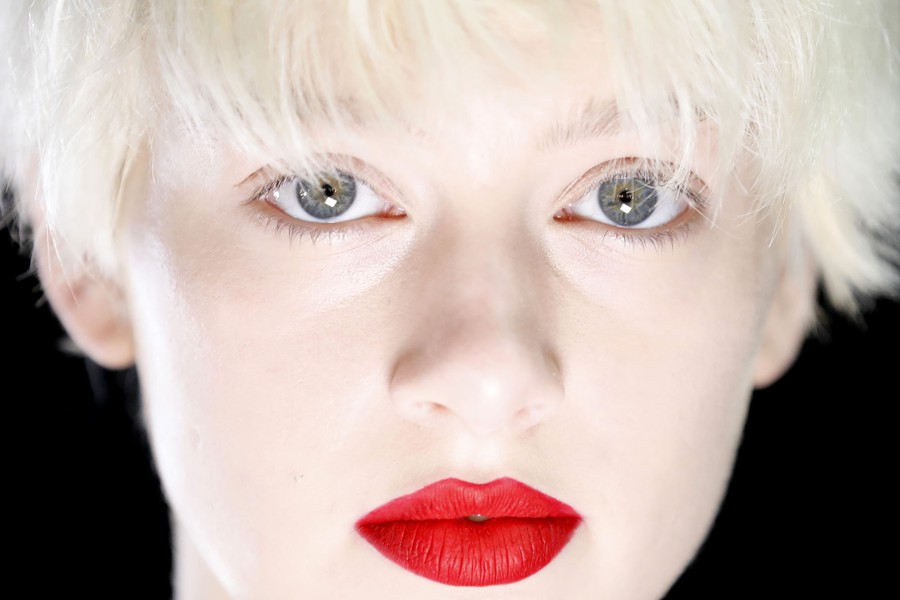 A close-up portrait of a model's face.