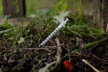 A syringe stuck into the ground