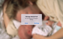 A "storage almost full" notification appears over a photo of a parent and their baby