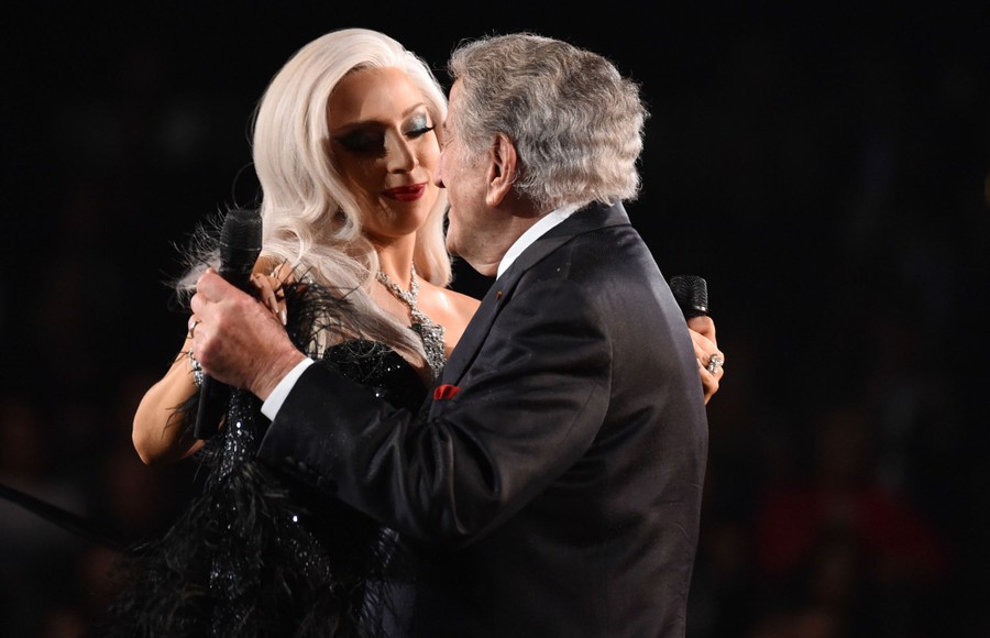 Lady Gaga and Tony Bennett dance while performing onstage.