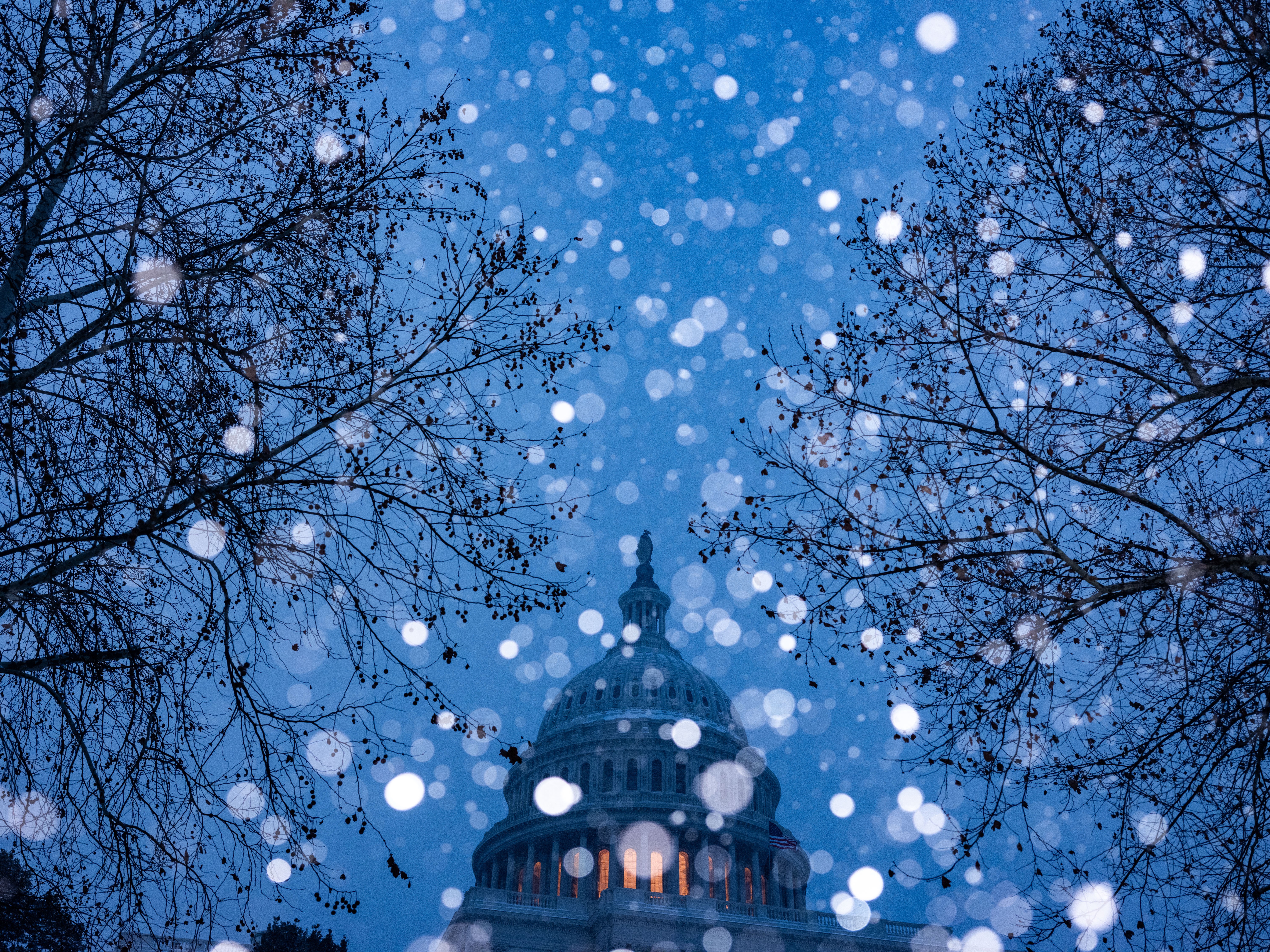 Snowflakes fall in front of the US Capitol Building.