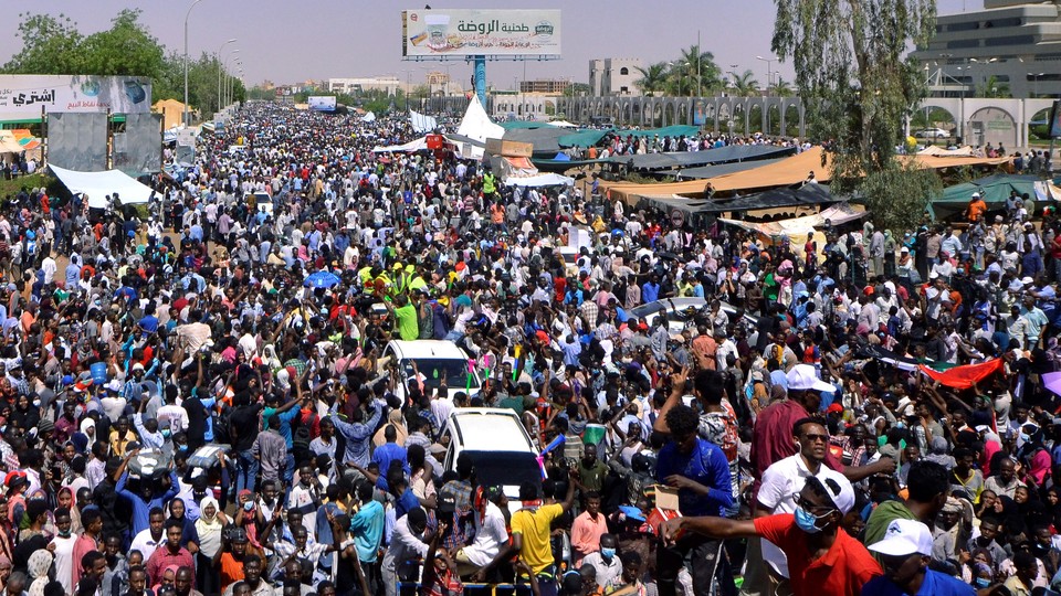 Sudanese demonstrators chant slogans during a protest in Khartoum demanding that Sudanese President Omar Al-Bashir step down.
